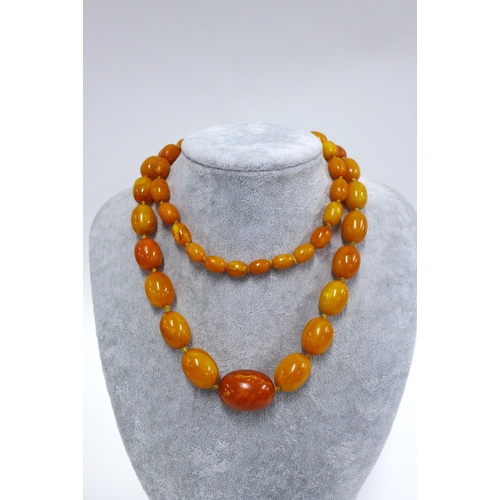 12 - Early 20th century graduating strand of faux butterscotch amber beads,