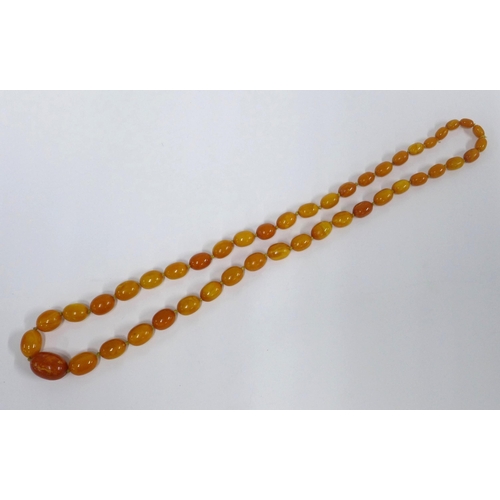 12 - Early 20th century graduating strand of faux butterscotch amber beads,