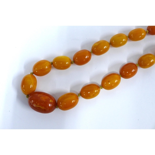 12 - Early 20th century graduating strand of faux butterscotch amber beads,