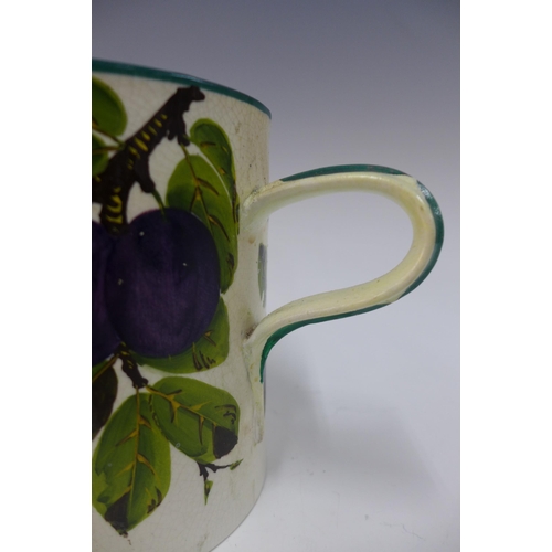 122 - Wemyss Ware plums pattern tyg, one handle restored, 14.5cm