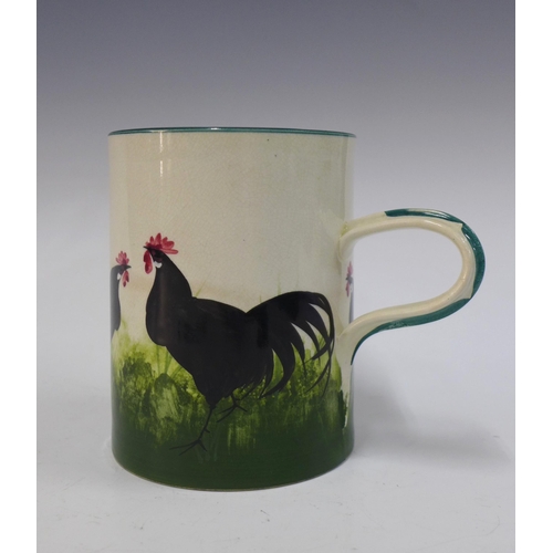 135 - Wemyss Ware, Robert Heron and Son, large black cockerel with hens mug, 14cm