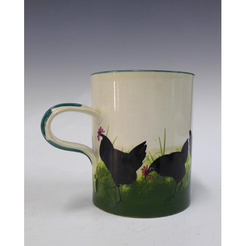 135 - Wemyss Ware, Robert Heron and Son, large black cockerel with hens mug, 14cm