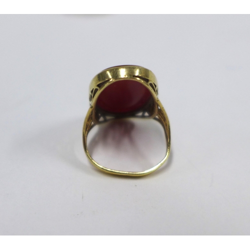 15 - 9ct gold ring with an oval carnelian on a pierced shank with London hallmarks