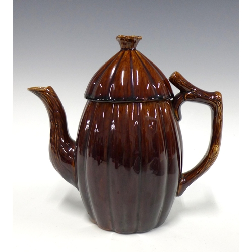 150 - 19th century treacle glazed teapot with the handle and spout in the form of branches, 22cm