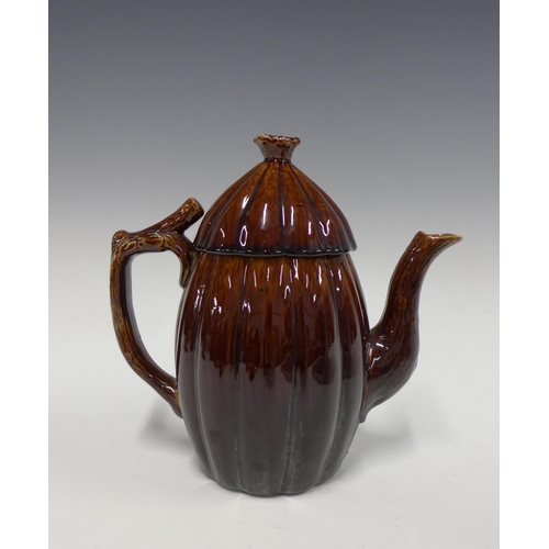 150 - 19th century treacle glazed teapot with the handle and spout in the form of branches, 22cm