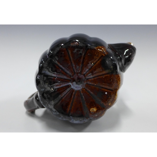 150 - 19th century treacle glazed teapot with the handle and spout in the form of branches, 22cm