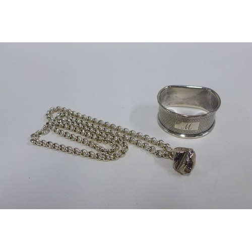 27 - Silver chain with a silver nugget, London 1977 and a London silver napkin ring (2)