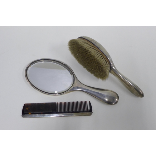 34 - Three piece silver backed dressing table brush set, (3)