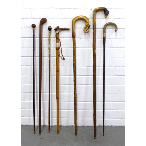 392 - Collection of walking sticks, including a duck head stick 100cm, an acorn head stick with silver mou... 