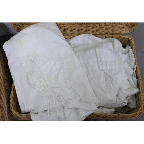 398 - Two wicker baskets, one containing white cotton nightwear and the other vintage table linens and cro... 