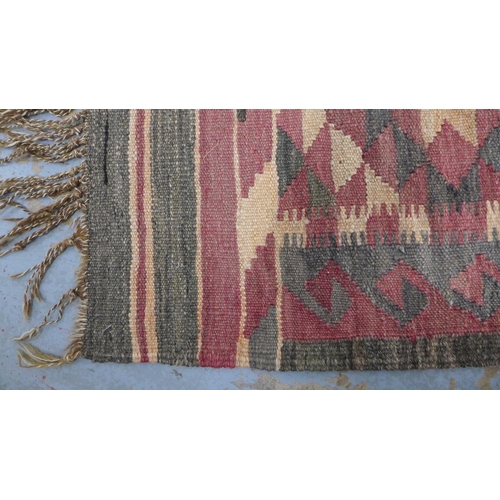 402 - Three bagface  cushions together with a small kilim rug, 98 x 68cm (4)