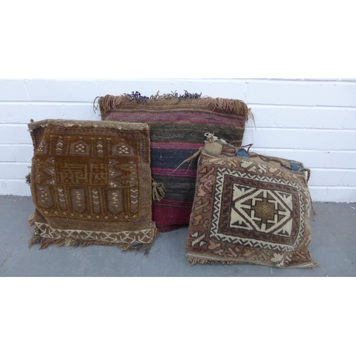 402 - Three bagface  cushions together with a small kilim rug, 98 x 68cm (4)