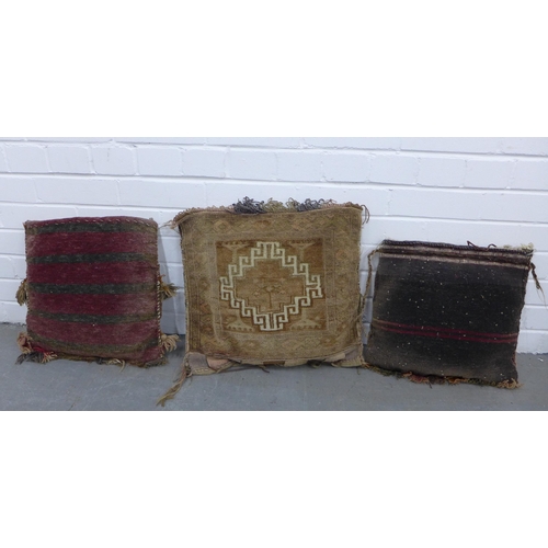 402 - Three bagface  cushions together with a small kilim rug, 98 x 68cm (4)