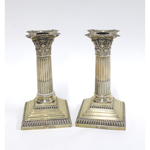 44 - A pair of Victorian silver candlesticks, by William Hutton & Sons, London 1895, corinthian column de... 