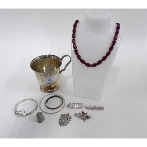 66 - A collection of silver jewellery to include brooches and bangles, a silver thimble and an Epns Chris... 