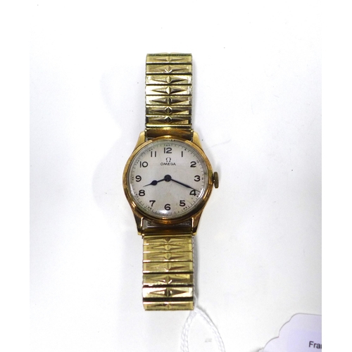 70 - OMEGA, a gents vintage gold cased wristwatch with silvered dial and Arabic numerals