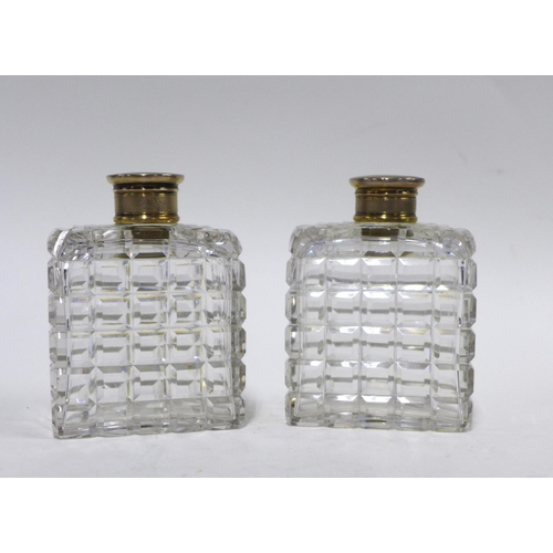 87 - A pair of cut glass scent bottles with Epns tops, (2) 10cm