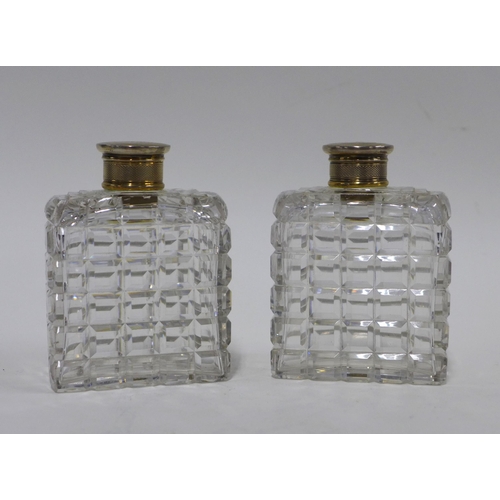 87 - A pair of cut glass scent bottles with Epns tops, (2) 10cm