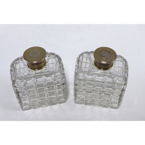 87 - A pair of cut glass scent bottles with Epns tops, (2) 10cm