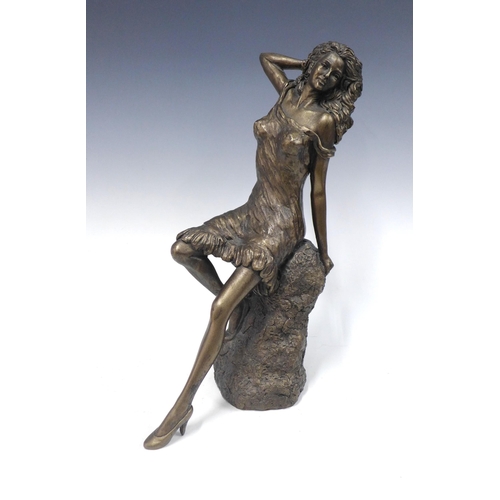 148 - Bronze patina resin figure of a reclining female figure, 38cm