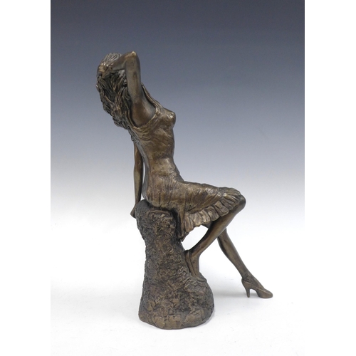 148 - Bronze patina resin figure of a reclining female figure, 38cm