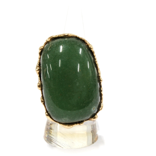 1 - A Columbian jadeite ring, the large polished cabochon set in unmarked yellow metal