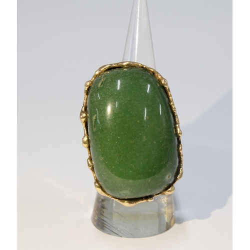 1 - A Columbian jadeite ring, the large polished cabochon set in unmarked yellow metal