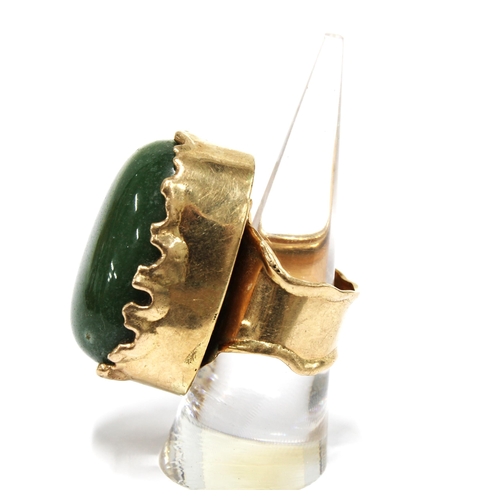 1 - A Columbian jadeite ring, the large polished cabochon set in unmarked yellow metal