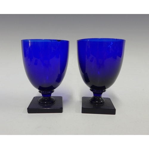 119 - Two Bristol blue wine glasses on square foot base, 13cm (2) (some rim chips)