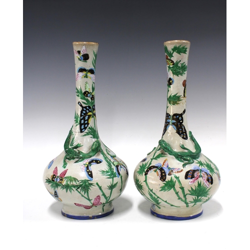 141 - Pair of Chinese bottle neck lizard vases, decorated with bamboo and butterflies, both a/f with repai... 