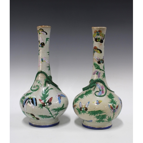 141 - Pair of Chinese bottle neck lizard vases, decorated with bamboo and butterflies, both a/f with repai... 