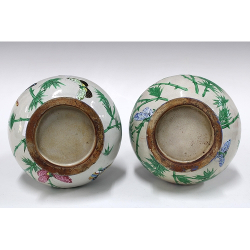 141 - Pair of Chinese bottle neck lizard vases, decorated with bamboo and butterflies, both a/f with repai... 