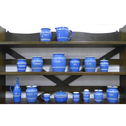 149 - Blue and white striped storage containers, including olive oil, haricot beans, candied peel, sugar, ... 