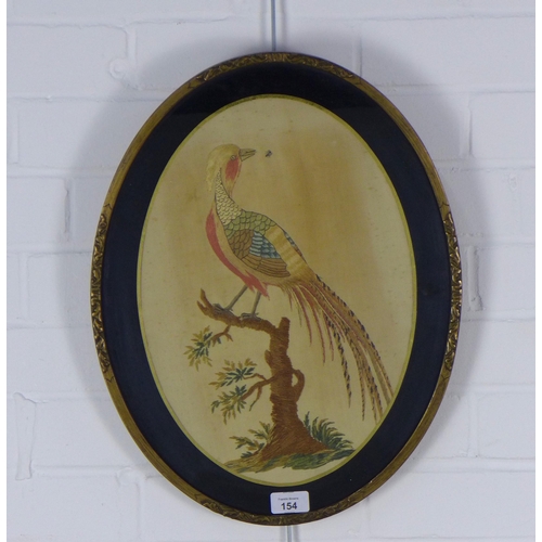 154 - Needlework on silk panel depicting a peacock, in a oval verre eglomise frame, 37 x 47cm