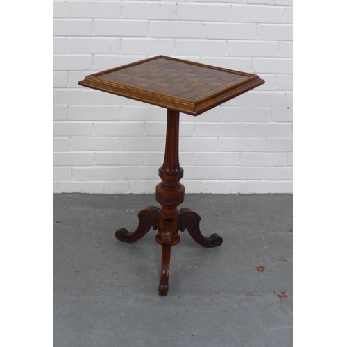 216 - An oak and mixed wood games table, with square checkerboard top with fluted column and carved tripod... 