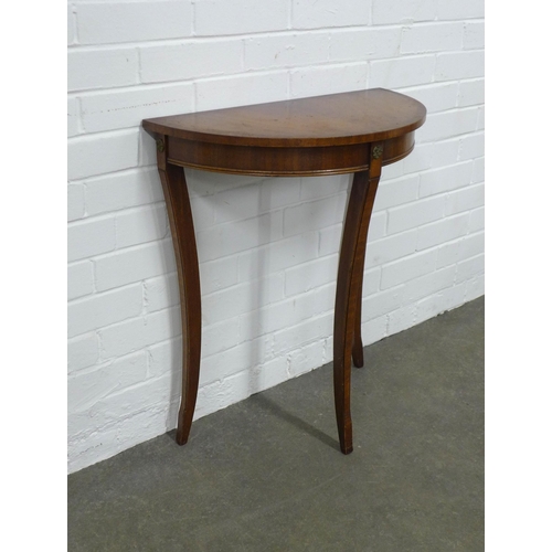 224 - Demilune consol table raised  on slender sabre legs, 61 x 70 x 31cm.