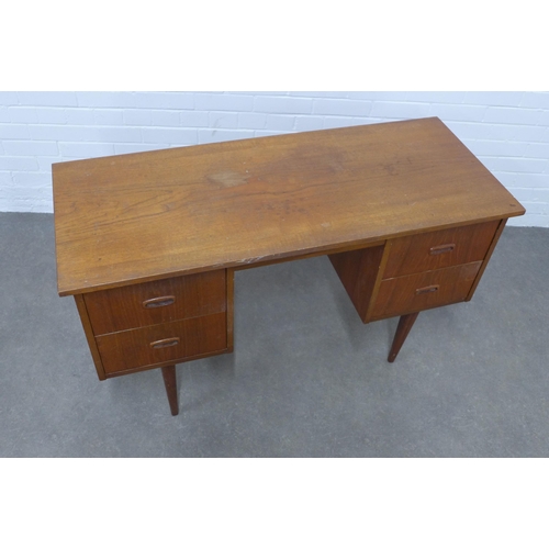 228 - Mid Century teak desk, medium size with two banks of two deep drawers, raised on tapering legs, 122 ... 