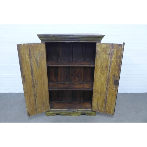 233 - An Indian cupboard with two panelled doors having a distressed painted finish, medium size and openi... 