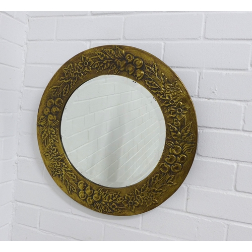 243 - Brass circular wall mirror with embossed fruit and flower frame, 48cm.