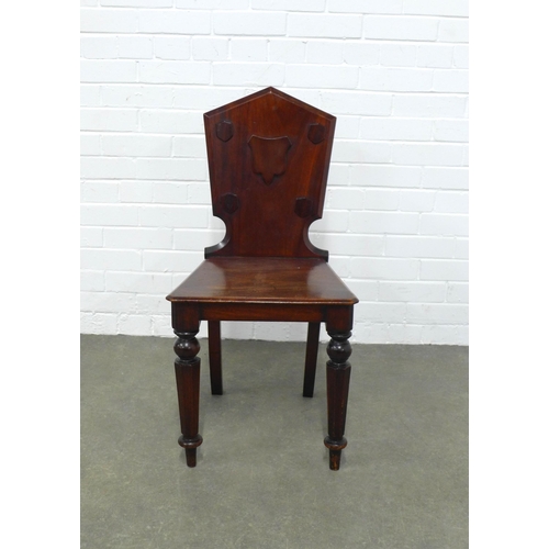 252 - Mahogany hall chair, shaped back with shield motif, solid seat and turned leg,  42 x 86 x 37cm.