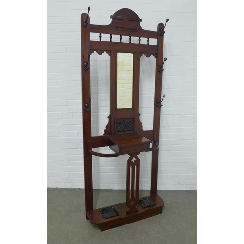 253 - An Edwardian mahogany hall stand, mirror back with six coat hooks and complete with metal drip trays... 