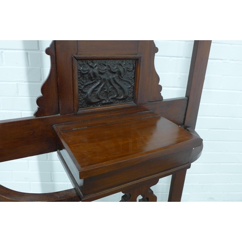 253 - An Edwardian mahogany hall stand, mirror back with six coat hooks and complete with metal drip trays... 