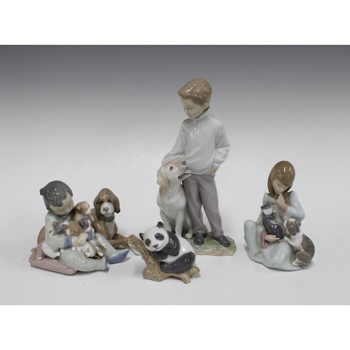 387 - Three Lladro figures of children with dogs, tallest 16cm, together with a Lladro panda (4)