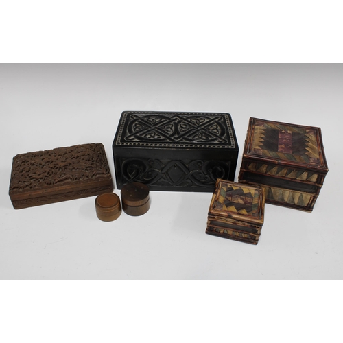 398 - Ebonised carved wooden box, 24 x 11cm, together with two straw boxes, an Indian box decorated with a... 