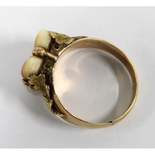 42 - 14ct gold ring with two hardstones within leafy border, stamped 585, size K