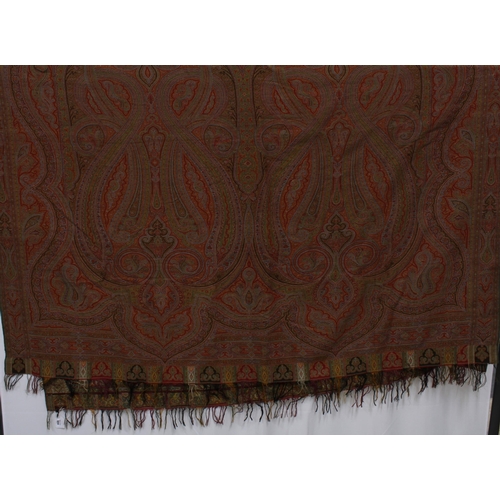 484 - A large Paisley shawl, finely woven in typical pattern and colours of red and green, 336 x 165cm.