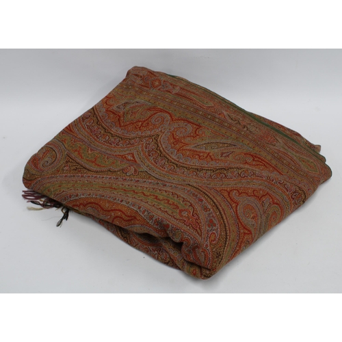 484 - A large Paisley shawl, finely woven in typical pattern and colours of red and green, 336 x 165cm.