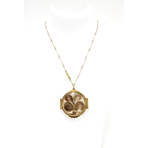 6 - 9ct gold chain with a gilt metal hair and seed mourning locket pendant