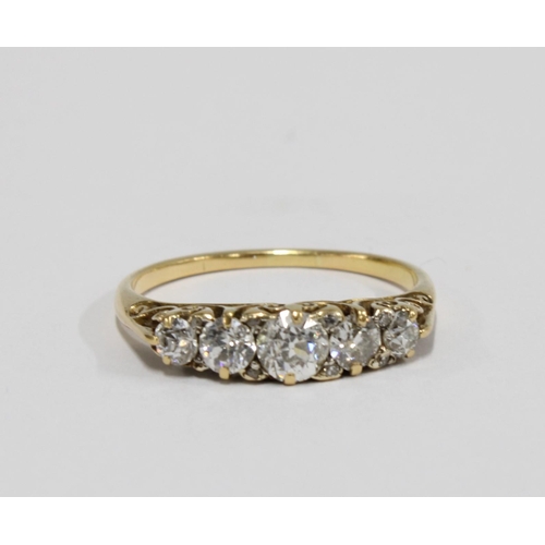 92 - Gold and diamond five stone ring, claw set with five graduating bright cut diamonds on a pierced and... 