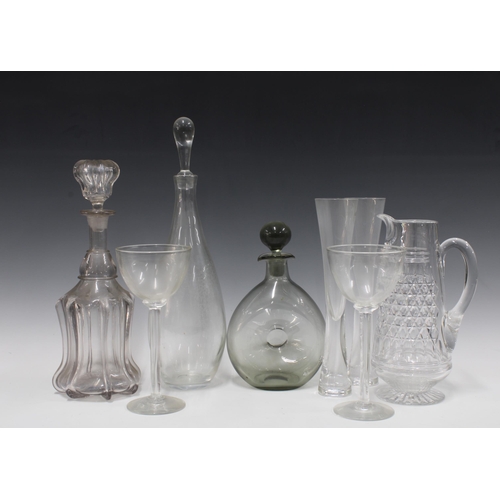 502 - Three various glass decanters with stoppers, a cut crystal water jug and champagne coups / flutes, (... 